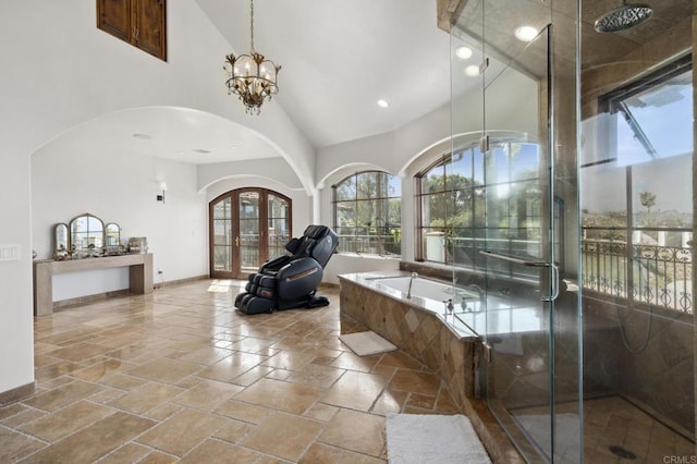 5955 Lake Vista Dr, Bonsall, CA 92003 - bathroom featuring high vaulted ceiling, french doors, stone tile floors, a shower stall, and a garden tub