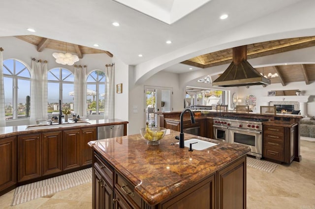 5955 Lake Vista Dr, Bonsall, CA 92003 - kitchen with arched walkways, a sink, stainless steel appliances, recessed lighting, and an island with sink