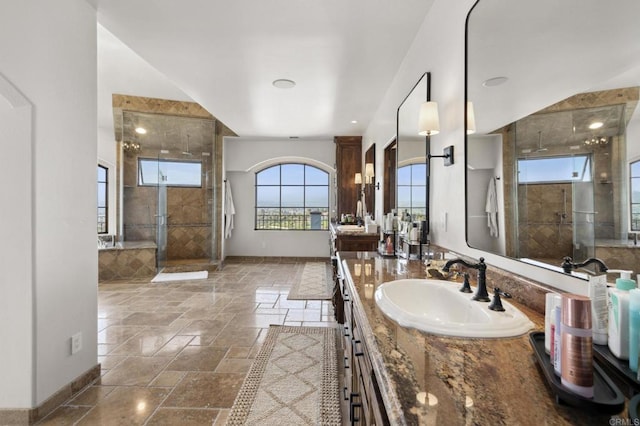 5955 Lake Vista Dr, Bonsall, CA 92003 - bathroom with baseboards, stone tile floors, vanity, and a shower stall