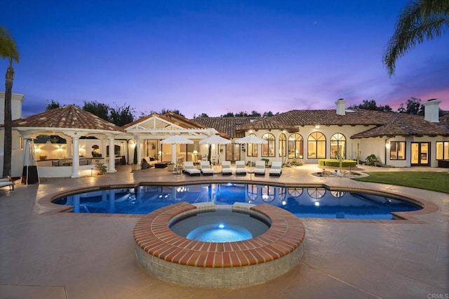 5955 Lake Vista Dr, Bonsall, CA 92003 - pool at dusk with a patio, a gazebo, and a pool with connected hot tub