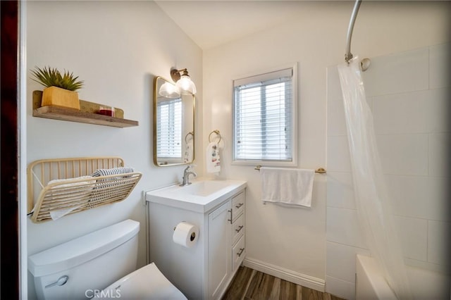 bathroom featuring wood finished floors, vanity, baseboards, toilet, and shower / bathtub combination with curtain