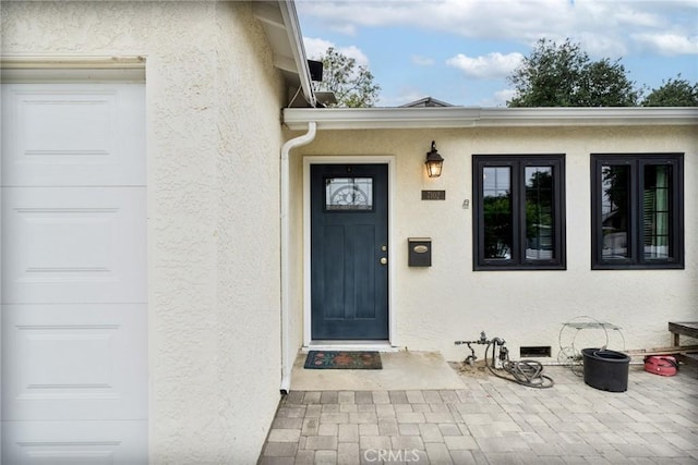 property entrance featuring stucco siding