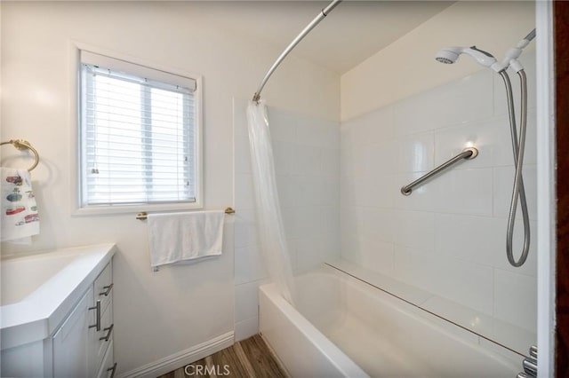 full bathroom with vanity, shower / tub combo with curtain, baseboards, and wood finished floors