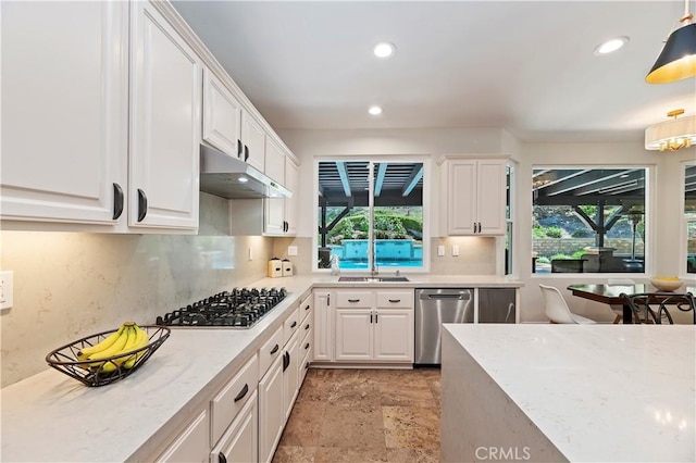 1560 Vandagriff Way, Corona, CA 92883 - kitchen featuring stainless steel appliances, under cabinet range hood, white cabinets, recessed lighting, and decorative backsplash