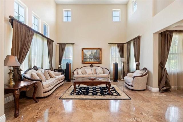 1560 Vandagriff Way, Corona, CA 92883 - living area with marble tiled floors, a high ceiling, plenty of natural light, and baseboards