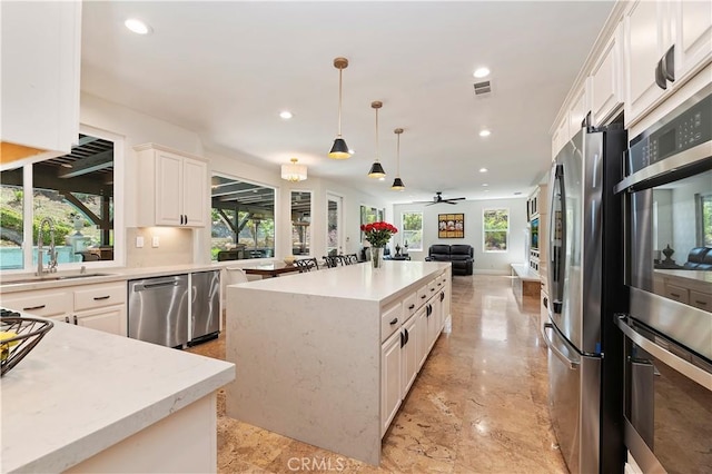 1560 Vandagriff Way, Corona, CA 92883 - kitchen featuring stainless steel appliances, a sink, a kitchen island, recessed lighting, and white cabinetry