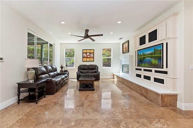 1560 Vandagriff Way, Corona, CA 92883 - living area featuring a ceiling fan, baseboards, recessed lighting, light marble finish flooring, and a glass covered fireplace