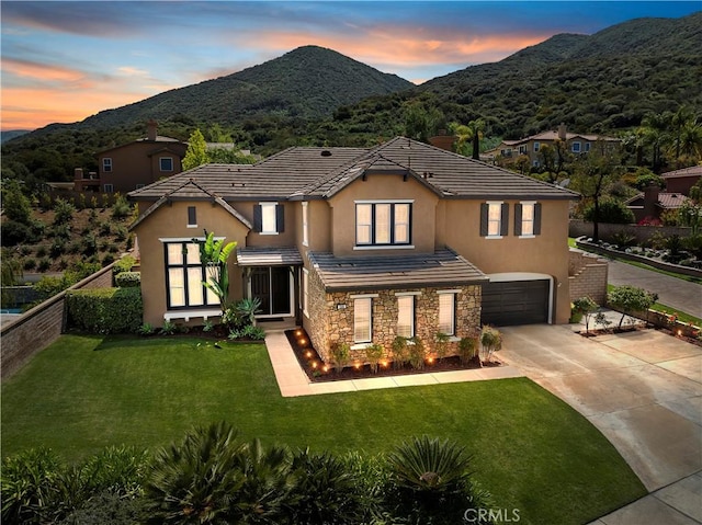 1560 Vandagriff Way, Corona, CA 92883 - view of front of home with an attached garage, stucco siding, concrete driveway, stone siding, and a mountain view
