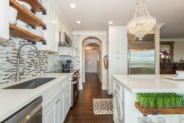102 Scholz Unit 28, Newport Beach, CA 92663 - kitchen with premium appliances, open shelves, a sink, white cabinets, and crown molding
