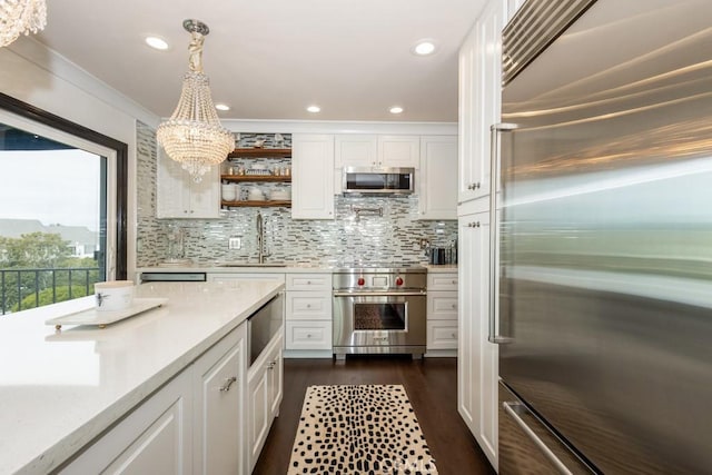 102 Scholz Unit 28, Newport Beach, CA 92663 - kitchen featuring stainless steel appliances, a sink, light countertops, white cabinetry, and crown molding