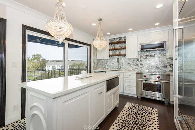 102 Scholz Unit 28, Newport Beach, CA 92663 - kitchen with appliances with stainless steel finishes, a sink, a chandelier, light countertops, and white cabinetry