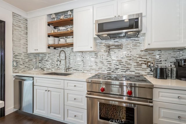 102 Scholz Unit 28, Newport Beach, CA 92663 - kitchen with stainless steel appliances, a sink, light countertops, and backsplash