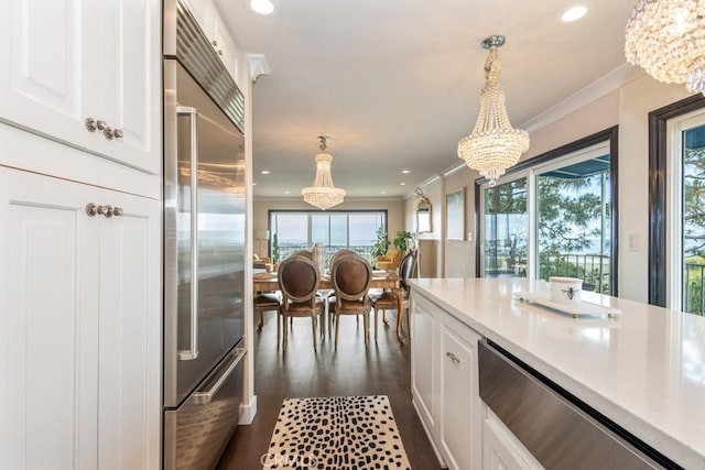 102 Scholz Unit 28, Newport Beach, CA 92663 - kitchen with stainless steel built in refrigerator, a chandelier, dark wood-style flooring, white cabinetry, and ornamental molding
