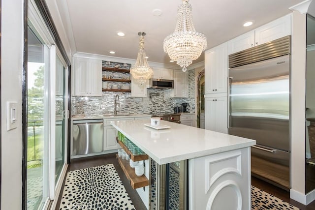 102 Scholz Unit 28, Newport Beach, CA 92663 - kitchen with stainless steel appliances, open shelves, light countertops, a chandelier, and tasteful backsplash