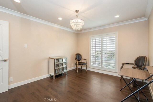 interior space with crown molding, baseboards, wood finished floors, and an inviting chandelier