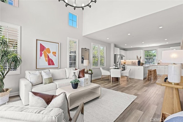 113 Soaring Eagle, Irvine, CA 92618 - living area featuring light wood-style flooring, recessed lighting, baseboards, and a chandelier