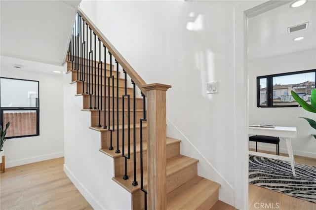 stairs with recessed lighting, wood finished floors, visible vents, and baseboards