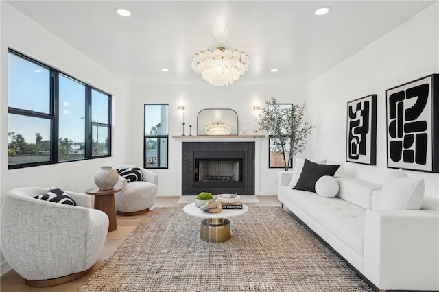 living room with light wood finished floors, a fireplace, and recessed lighting