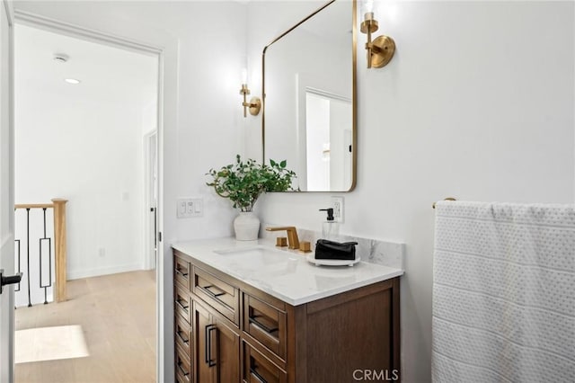bathroom featuring wood finished floors and vanity