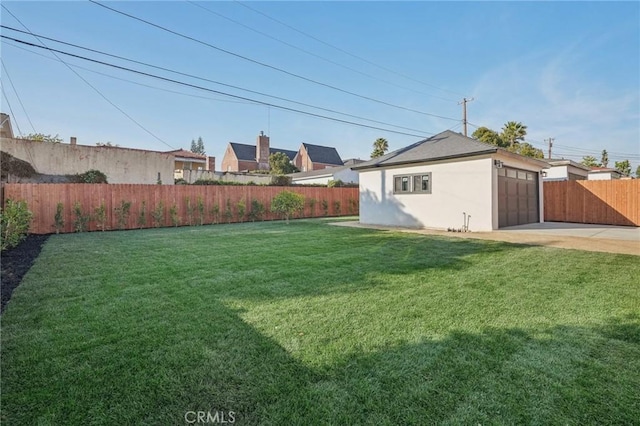 view of yard featuring a garage, driveway, and fence