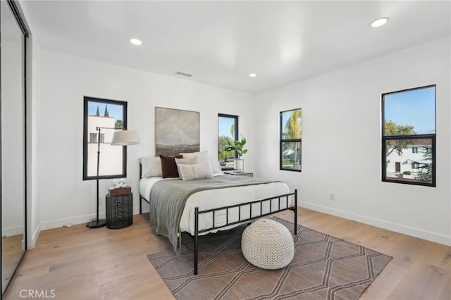 bedroom with recessed lighting, visible vents, and light wood-type flooring
