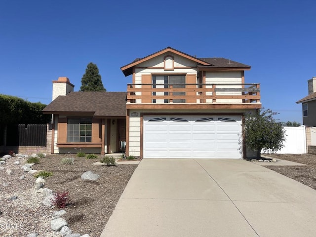 traditional-style home with roof with shingles, a chimney, concrete driveway, fence, and an attached garage