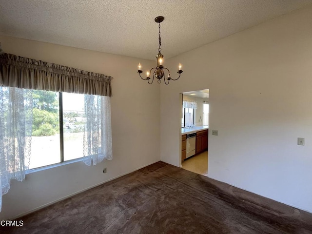 unfurnished dining area with light colored carpet, a chandelier, and a textured ceiling