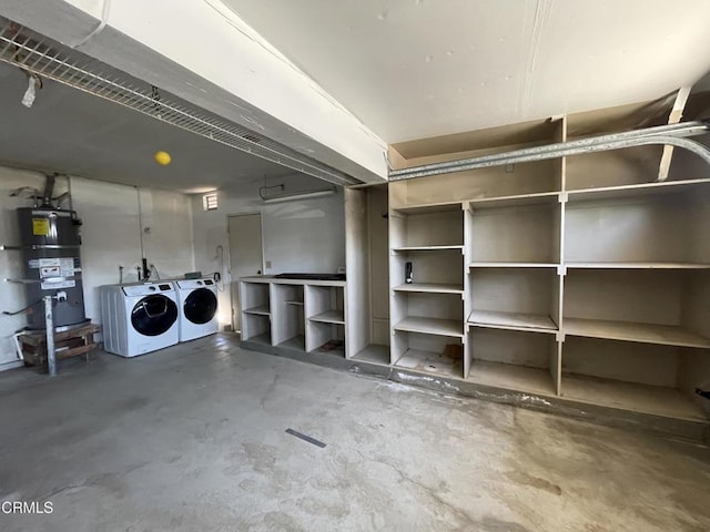 garage with secured water heater and washing machine and clothes dryer