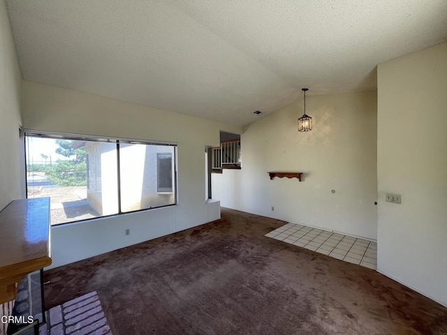 unfurnished living room with carpet floors and lofted ceiling