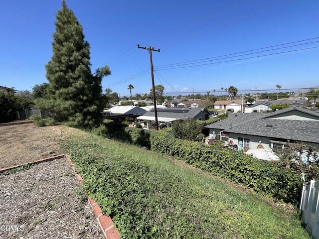 view of yard featuring a residential view and fence