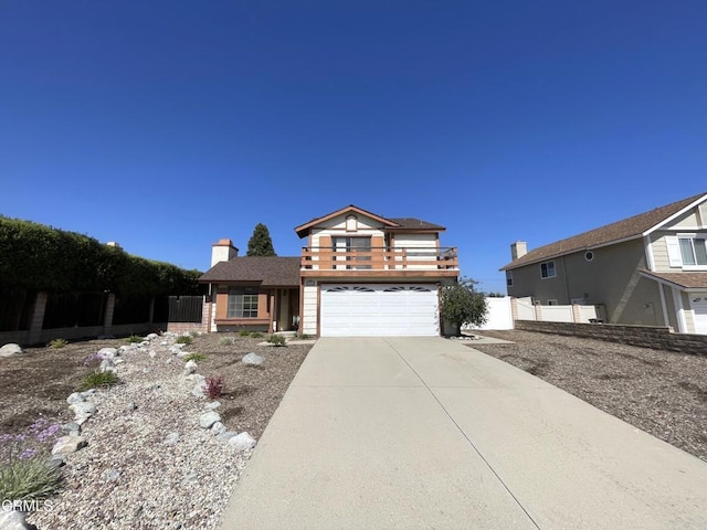 traditional-style house featuring fence, driveway, a chimney, and a garage