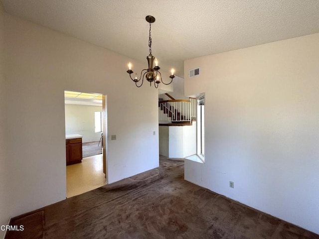 unfurnished dining area featuring an inviting chandelier, carpet floors, stairs, and visible vents