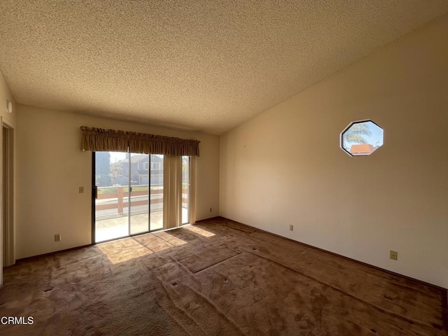 spare room featuring carpet floors and a textured ceiling