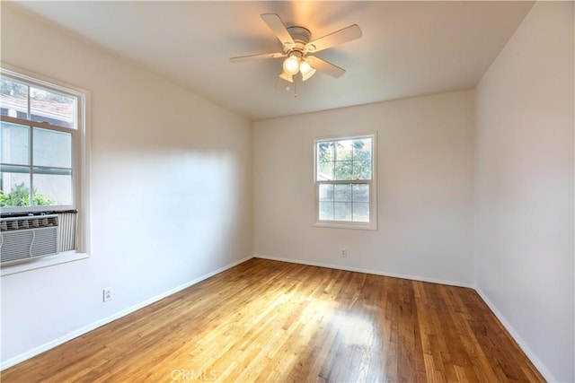 5032 Verdura Ave, Lakewood, CA 90712 - empty room with wood-type flooring, cooling unit, a wealth of natural light, and baseboards