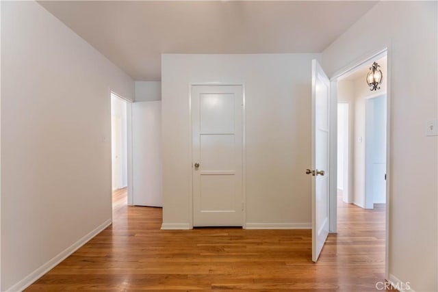 interior space featuring light wood finished floors and baseboards