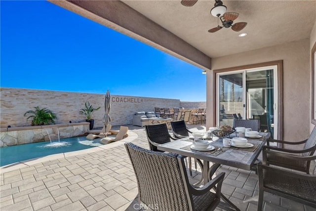 view of patio with a fenced backyard, ceiling fan, and outdoor dining area