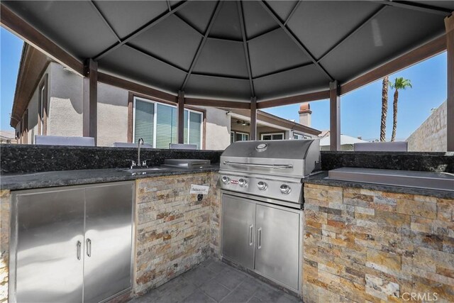view of patio / terrace featuring a gazebo, a sink, and area for grilling