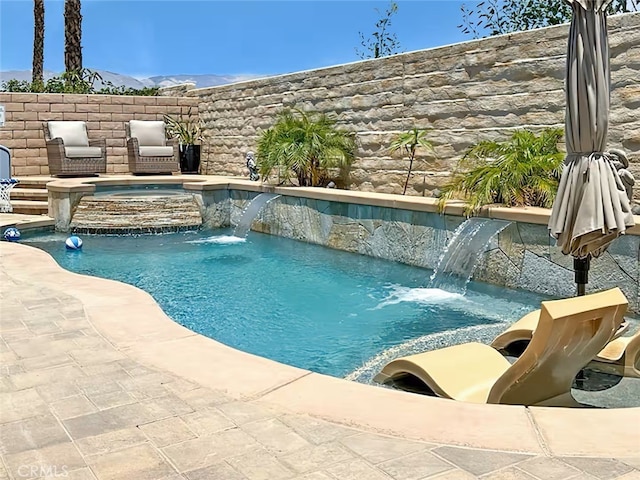 view of pool with a fenced in pool and an in ground hot tub