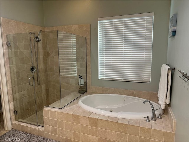 bathroom featuring a bath and a stall shower