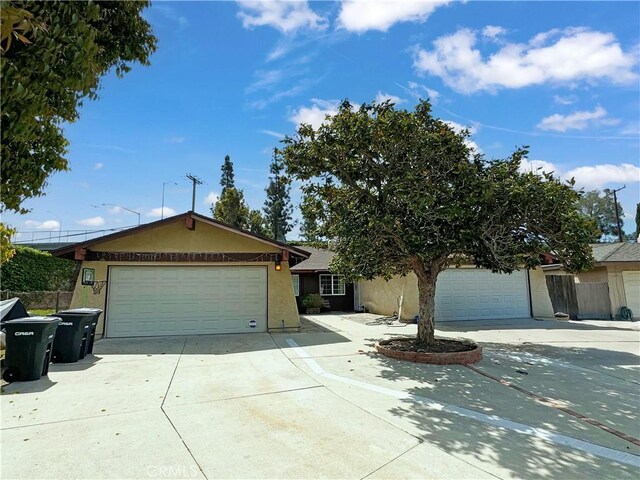 2032 E Stearns Ave, Orange, CA 92866 - ranch-style home with stucco siding, driveway, and a garage