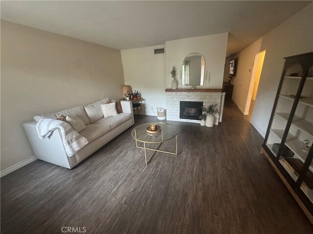 2032 E Stearns Ave, Orange, CA 92866 - living area with dark wood-style floors, a fireplace, and baseboards