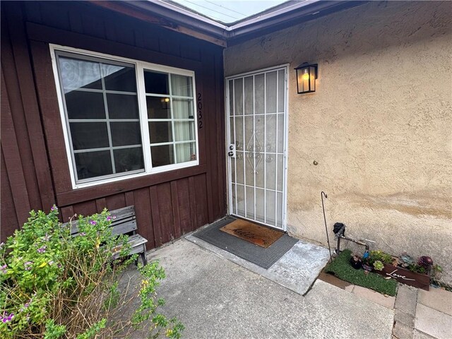 2032 E Stearns Ave, Orange, CA 92866 - entrance to property featuring a patio area and board and batten siding