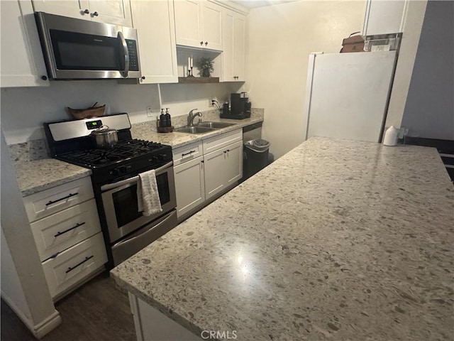 2032 E Stearns Ave, Orange, CA 92866 - kitchen with stainless steel appliances, a sink, open shelves, white cabinets, and light stone counters