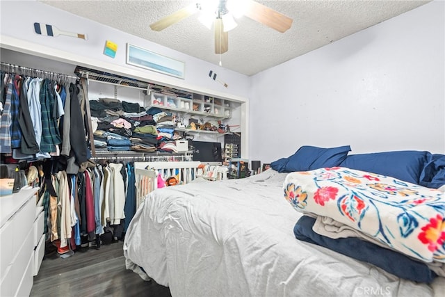 bedroom featuring ceiling fan, a textured ceiling, and wood finished floors