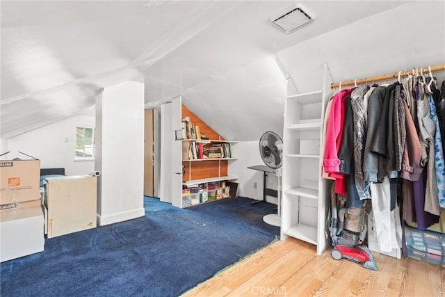 interior space featuring wood finished floors and lofted ceiling