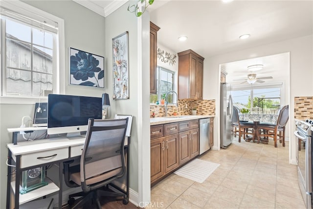 office space featuring a sink, a ceiling fan, and a wealth of natural light