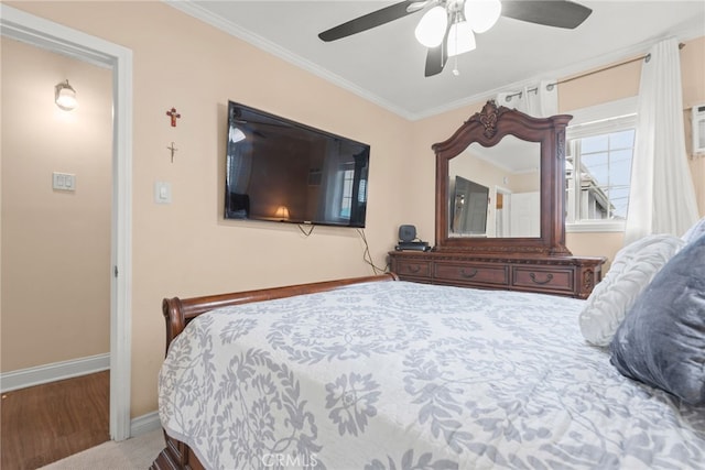 bedroom with baseboards, ornamental molding, ceiling fan, and wood finished floors