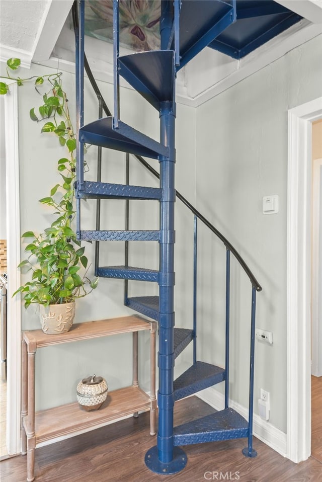 stairs featuring baseboards and wood finished floors