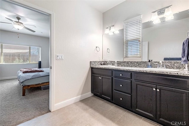 1628 N Delbert Ave, Fresno, CA 93722 - ensuite bathroom with baseboards, a ceiling fan, and a sink