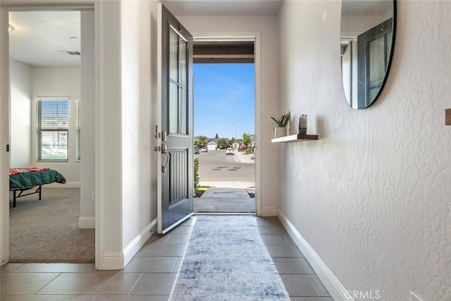 1628 N Delbert Ave, Fresno, CA 93722 - entryway with baseboards, a textured wall, tile patterned flooring, and visible vents